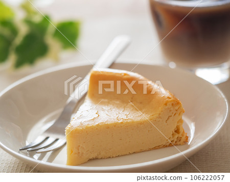 Baked cheesecake and iced coffee on a white plate 106222057