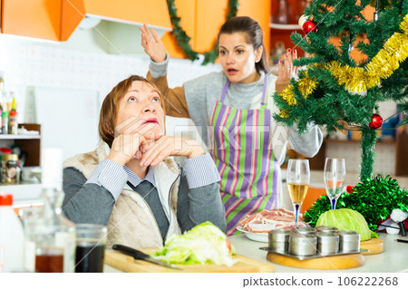 Woman having conflict with daughter during cooking xmas dinner Woman having conflict with daughter during cooking xmas dinner 106222268