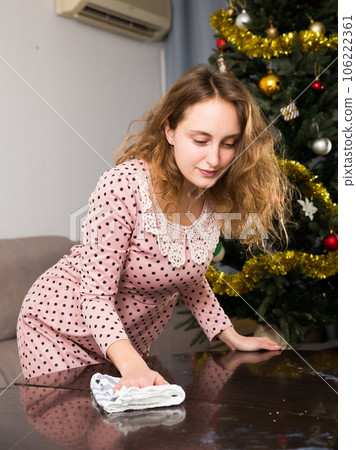 Woman wiping table before dinner Woman wiping table before dinner 106222361