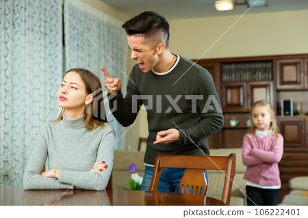 Husband screams at his wife with small child Husband screams at his wife with small child 106222401