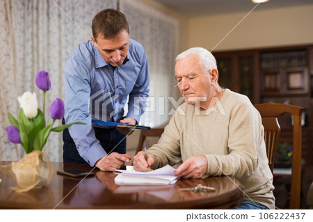 Man filling out papers 106222437