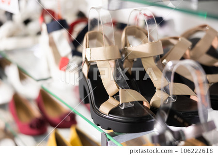 Womens sandals of latest summer collection are presented on glass window of store 106222618