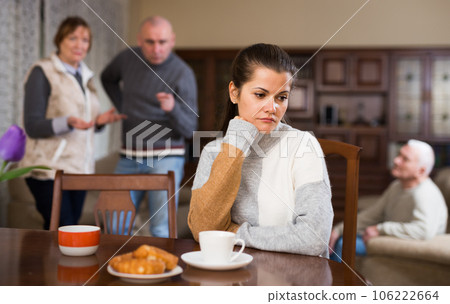 Offended woman sitting by table 106222664
