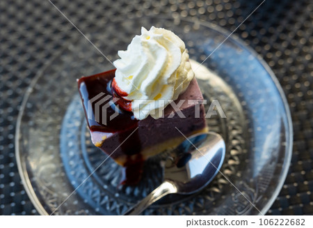 Pieces of cranberry cheesecake tart on wooden table. Pieces of cranberry cheesecake tart on wooden table. 106222682