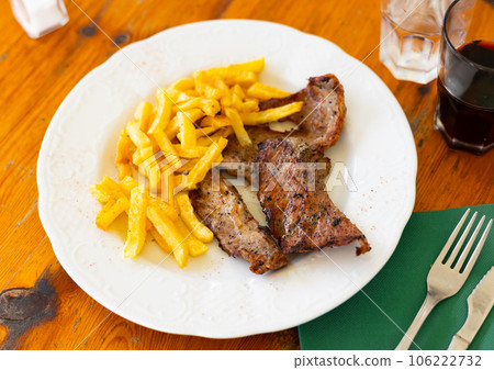 Delicious fried veal meat served with fried potato. 106222732