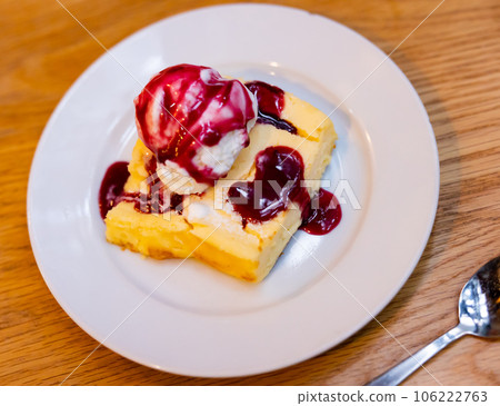 Pieces of cranberry cheesecake tart on wooden table. 106222763