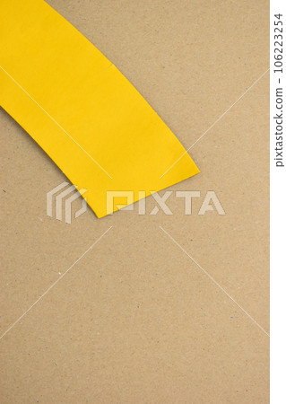 yellow curve paper put on brown background yellow curve paper put on brown background 106223254