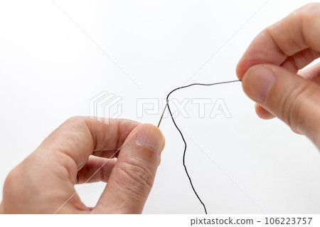 thread threaded through needle 106223757