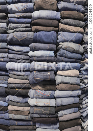 Stack of various blue jeans , 106224499