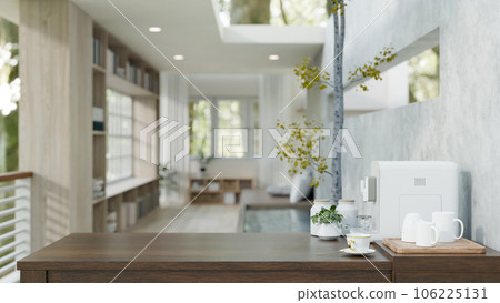 Copy space on a wooden tabletop with a coffee maker and a mug try in a modern living room. 106225131