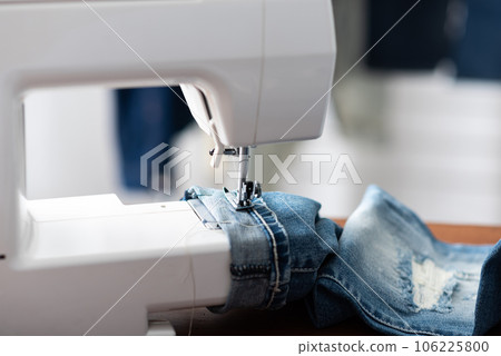 tailor working with jeans. 106225800