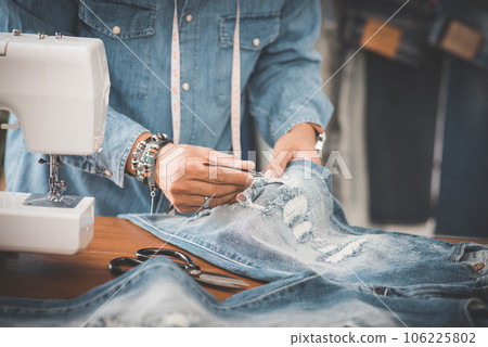 tailor working with jeans. tailor working with jeans. 106225802