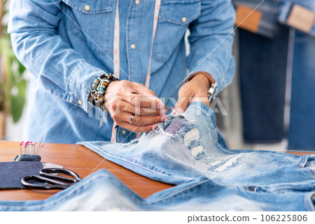tailor working with jeans. tailor working with jeans. 106225806