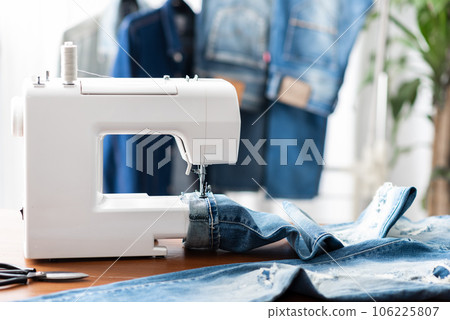 tailor working with jeans. tailor working with jeans. 106225807