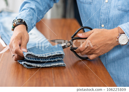 tailor working with jeans. 106225809