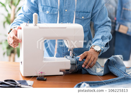 tailor working with jeans. 106225813
