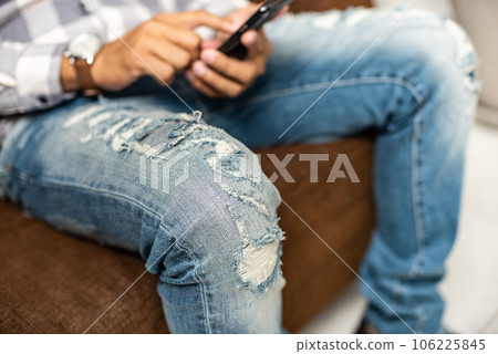 torn on blue jeans 106225845