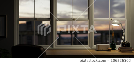 Close-up image of a copy space on a wooden table against the window with a sunset view 106226503