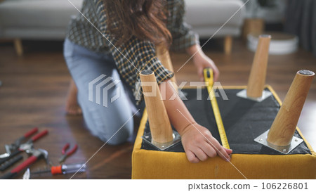 Women use measure tape equipment to measuring size of chair while assembling furniture for new home Women use measure tape equipment to measuring size of chair while assembling furniture for new home 106226801