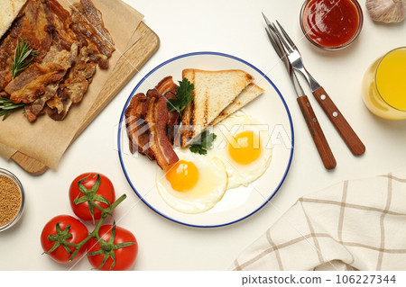 Tasty breakfast and delicious meat food concept - fried bacon Tasty breakfast and delicious meat food concept - fried bacon 106227344