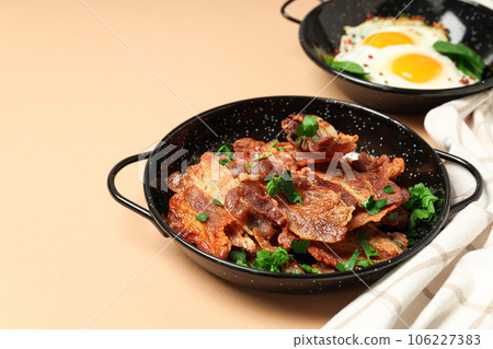 Tasty breakfast and delicious meat food concept - fried bacon Tasty breakfast and delicious meat food concept - fried bacon 106227383