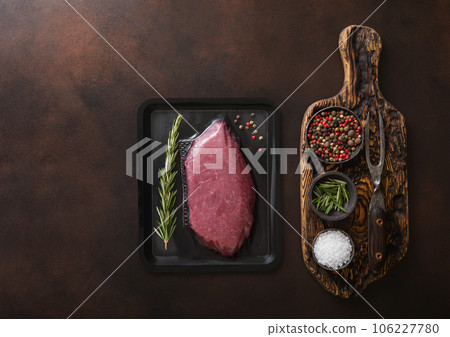 Chopping board with salt,pepper and rosemary with raw beef fillet sirloin steak 106227780