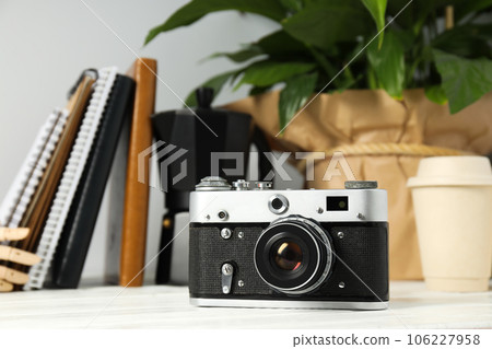 Vintage camera, notebooks and flower on white background, close up 106227958