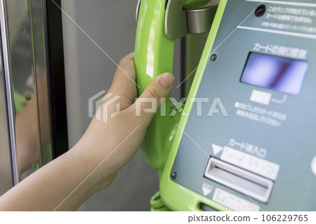 Child hand making a call from a public phone Child hand making a call from a public phone 106229765
