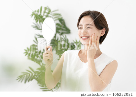 一個女人看著鏡子微笑著美麗 106232081