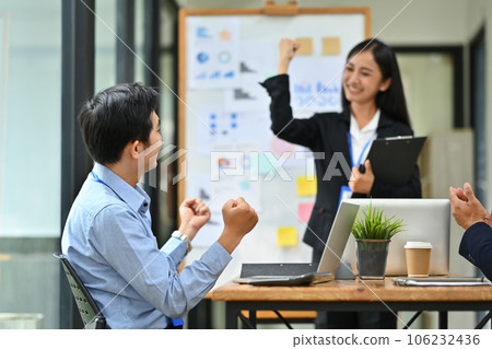 Happy business team excited by good news online on laptop, celebrating project success Happy business team excited by good news online on laptop, celebrating project success 106232436