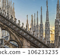 Flying buttress and rows of pinnacle sculptures on the rooftop aisle of Milan Cathedral 106233235