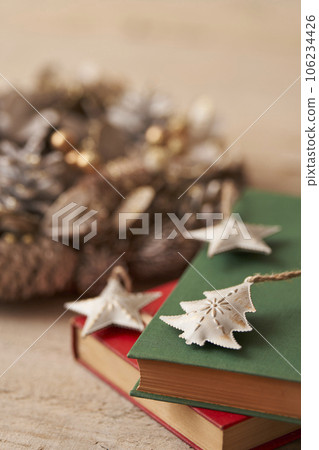 Christmas image Ornaments and Christmas wreath placed on old books Christmas image Ornaments and Christmas wreath placed on old books 106234426