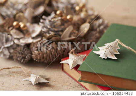 Christmas image Ornaments and Christmas wreath placed on old books Christmas image Ornaments and Christmas wreath placed on old books 106234433