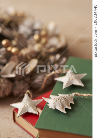 Christmas image Ornaments and Christmas wreath placed on old books 106234440