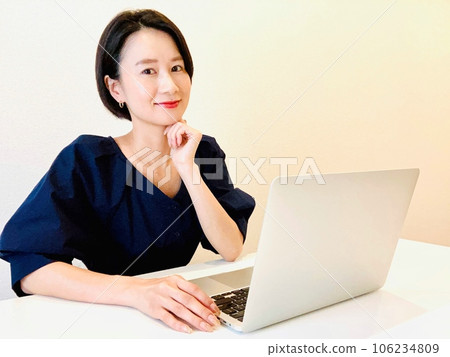A woman thinking in front of a personal computer A woman thinking in front of a personal computer 106234809