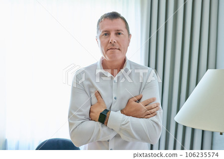 Business mature man in white shirt looking at camera in office interior 106235574