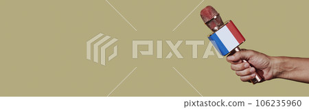 holds a mic patterned with the french flag, banner holds a mic patterned with the french flag, banner 106235960