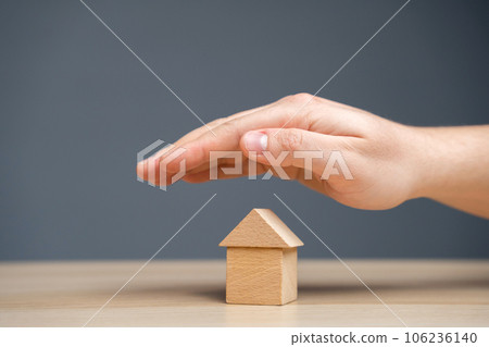 Insurance agent protects the house with a gesture of protection. The concept of property insurance protection and housing. Security and safety in the home. Life insurance and family. Real estate Insurance agent protects the house with a gesture of protection. The concept of property insurance protection and housing. Security and safety in the home. Life insurance and family. Real estate 106236140