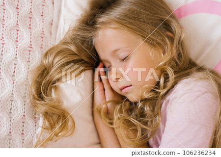 Cute girl sleeps sweetly on a pillow Cute girl sleeps sweetly on a pillow 106236234