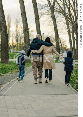 Happy family on a walk in the park 106237063