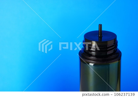 Black electronic cigarettes liquid bottle on blue background 106237139