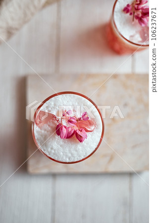 Thai style iced pink milk.Cold sweet drink Red Grenadien Sugar Syrup mix with milk and iced cube in glass 106237671