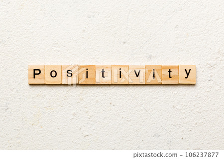 positivity word written on wood block. positivity text on cement table for your desing, concept 106237877