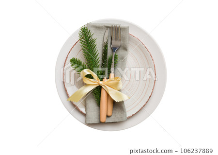 isolated christmas Plate with decor and fork and spoon. New year holiday background. Top view 106237889