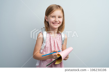 Little girl taking notes in notebook using colored pencil Little girl taking notes in notebook using colored pencil 106238106