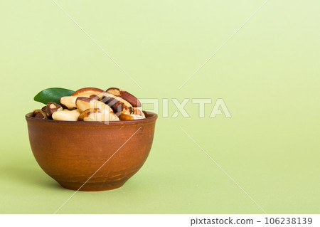 Fresh healthy Brazil nuts in bowl on colored table background. Top view Healthy eating bertholletia concept. Super foods Fresh healthy Brazil nuts in bowl on colored table background. Top view Healthy eating bertholletia concept. Super foods 106238139