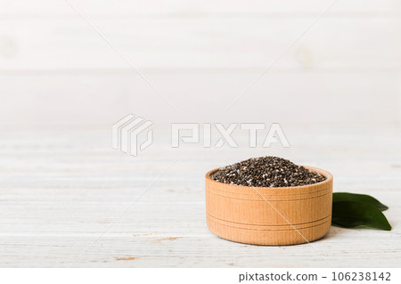 Chia seeds in bowl on colored background. Healthy Salvia hispanica in small bowl. Healthy superfood Chia seeds in bowl on colored background. Healthy Salvia hispanica in small bowl. Healthy superfood 106238142