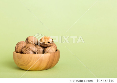 Fresh healthy walnuts in bowl on colored table background. Top view Healthy eating bertholletia concept. Super foods Fresh healthy walnuts in bowl on colored table background. Top view Healthy eating bertholletia concept. Super foods 106238150