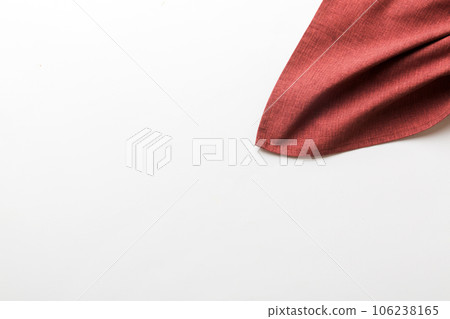 top view with red empty kitchen napkin isolated on table background. Folded cloth for mockup with copy space, Flat lay. Minimal style top view with red empty kitchen napkin isolated on table background. Folded cloth for mockup with copy space, Flat lay. Minimal style 106238165