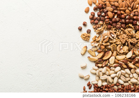 different nuts frame background. Close up, top view, flat lay with vopy space. Walnut, pistachios, almonds, hazelnuts and cashews different nuts frame background. Close up, top view, flat lay with vopy space. Walnut, pistachios, almonds, hazelnuts and cashews 106238166